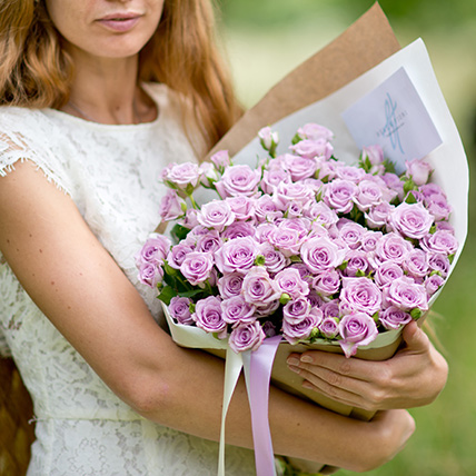 Нежно-фиолетовые кустовые розы в крафте